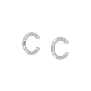 Macro shot of silver C-shaped minimalist hoop earrings with high-polish metallic finish