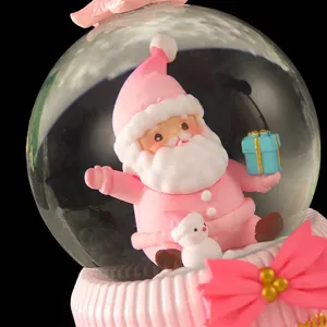 Pink Christmas water globe with Santa Claus, glitter snow, and pink bow resin base