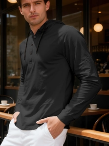 Close-up of black hooded shirt with button placket and breathable fabric texture