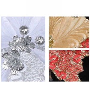 Detailed macro view of three-layer glitter Christmas flower ornaments in silver and gold