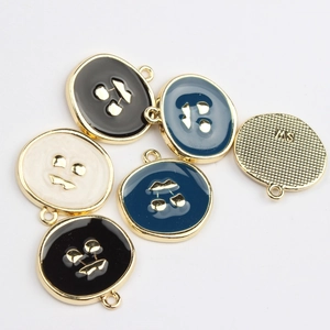 Detail of round cherry enamel charms with gold frames for DIY earring jewelry making