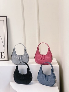 Chic crescent underarm bags in silver, pink, black, and jacquard displayed on steps