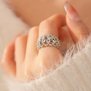 Close-up of a two-tone lace ring with zircon stones worn on a finger for a luxury look