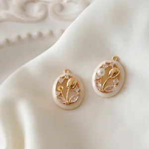Gold-plated tulip flower oval pendant with cream enamel, pearls, and zircons on silk