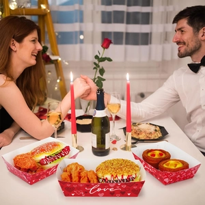 Romantic dinner setting showing red Valentine's Day themed snack trays for food.
