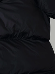 Detail of waist elastic shirring on black hooded winter puffer jacket with glossy finish