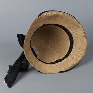 Japanese style hand-woven straw sun hat with black ribbon bow and pearl beads detail