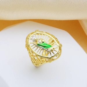Gold-plated hollow oval ring featuring green enamel mythological figure and halo design