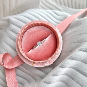 Detailed macro view of S925 silver six-prong diamond ring in a pink velvet box
