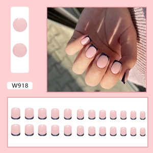 Macro view of W918 press-on nails featuring pink base with black glitter French tips