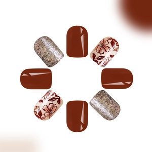 Glossy short press-on nails set with deep burgundy, gold glitter, and floral patterns