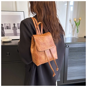 Close-up of vintage brown drawstring backpack with retro distressed faux leather texture
