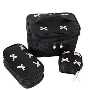 3-piece black nylon makeup bag set with 3D pink bows and pearl zipper pulls