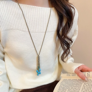 Detail showing the vintage bronze long necklace with blue turquoise teardrop tassel fringe