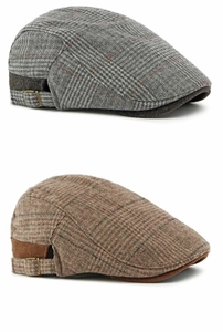 Detail of gray and brown plaid wool tweed newsboy caps with adjustable metal side buckles