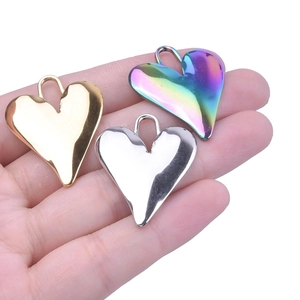 Polished stainless steel heart pendants in gold, silver, and rainbow finishes