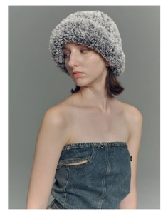 Close-up of thick grey and black gradient faux fur bucket hat with soft plush texture