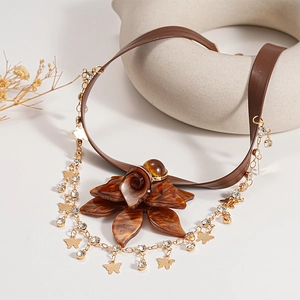 Vintage floral choker with brown leather, gold butterfly charms, and resin flower pendant