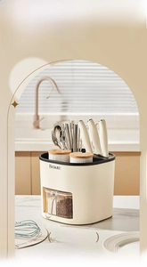 Detail view of multifunctional cream-white rotating knife rack with four integrated spice jars