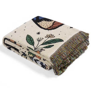Bohemian woven camping blanket with bird and floral pattern featuring colorful tassels