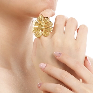 Artistic gold monstera leaf ring for women worn by a model in a high-fashion portrait