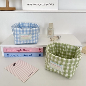 Close-up of quilted cotton storage baskets in blue and green checkerboard patterns