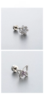Detailed macro view of star and butterfly zircon earrings with screw back closures