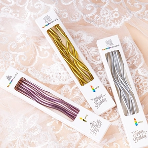 Metallic spiral birthday candles in gold, silver, and purple colors for party cakes
