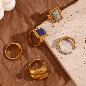 Detailed close-up of vintage 18K gold-plated rings with turquoise and lapis gemstones