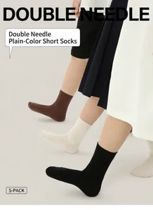 Detail of ribbed knit texture on kids cotton socks in brown, beige and black five-pack