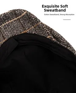Detail of grey herringbone newsboy hat showing soft cotton sweatband and inner lining