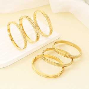 Detailed set of 18K gold plated stainless steel bangles with intricate crystal pavé and engravings