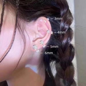Sparkling zircon ball stud earrings shown in 3mm to 6mm sizes on a female model