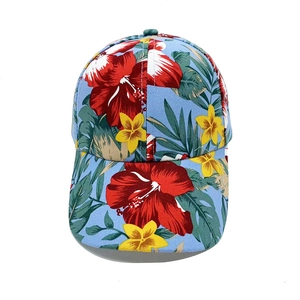 Floral print baseball cap with tropical hibiscus pattern on a light blue fabric base