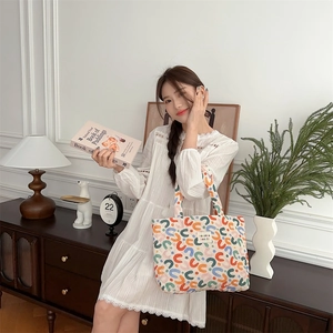 Detailed view of quilted tote bag with colorful abstract pattern in a stylish interior