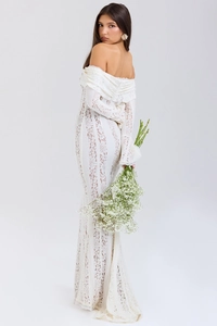 Close-up of white lace dress featuring elegant off-shoulder neckline and floral lace details