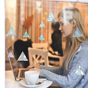 Rainbow prism static cling film featuring triangle patterns on a glass window