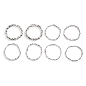 Set of eight silver metal beaded bracelets in various sizes with polished finish