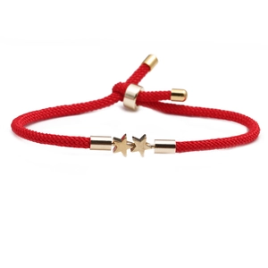 Red braided cord bracelet with two gold star charms and adjustable metallic finish