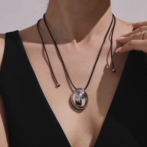 Minimalist high-polished silver oval pendant on long black leather cord necklace