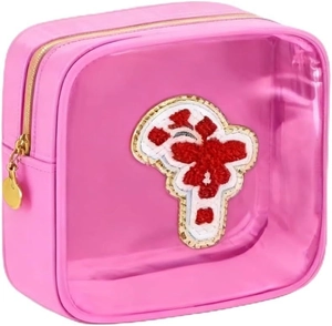 Detail of pink transparent makeup bag with festive chenille embroidery and gold zipper
