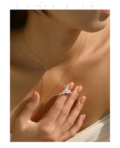 Macro view of a silver mermaid tail necklace featuring delicate pearl inlay and fine chain