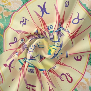 Macro detail of zodiac tapestry fabric with Pisces and Libra patterns in spiral fold