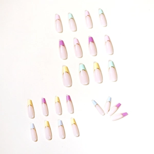 Rainbow French tip press-on nails in colorful coffin shape with gold glitter outlines