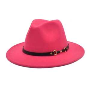 Close-up of rose red wool fedora hat featuring a black leather band and gold buckle