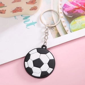 Close-up of a classic black and white PVC soccer ball keychain with a silver metal ring