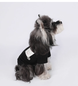 Close-up of black cotton pet T-shirt featuring a cartoon dog patch and soft knit texture