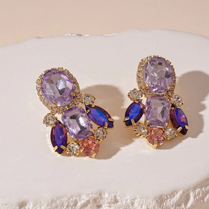 Close-up of geometric cluster earrings with colorful crystals and rhinestones