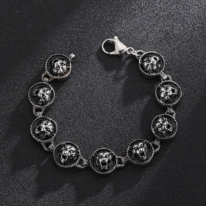 Macro shot of tiger head embossed links on a punk style stainless steel men's bracelet