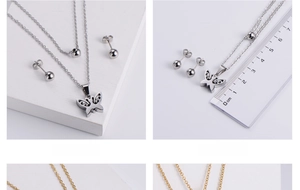 Detailed view of hollow butterfly pendant and bead earrings with ruler for scale